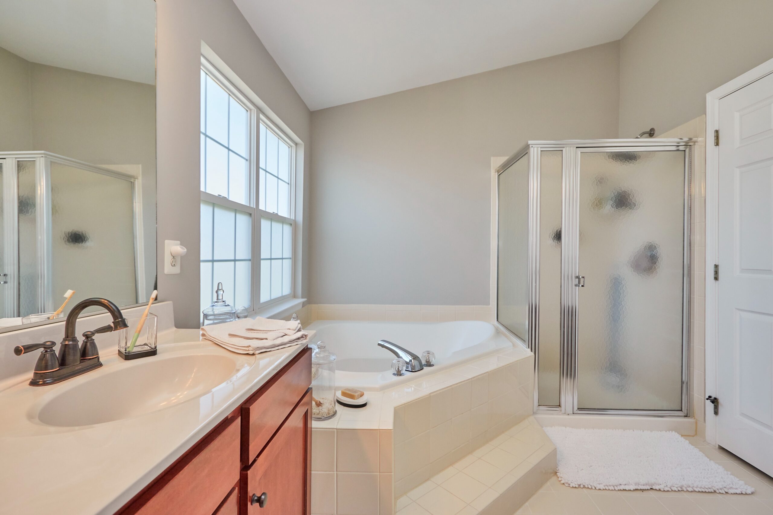 Professional interior photo of 25499 Beresford Drive, Chantilly, Virginia - showing the primary bathroom with jacuzzi tub and walk in shower