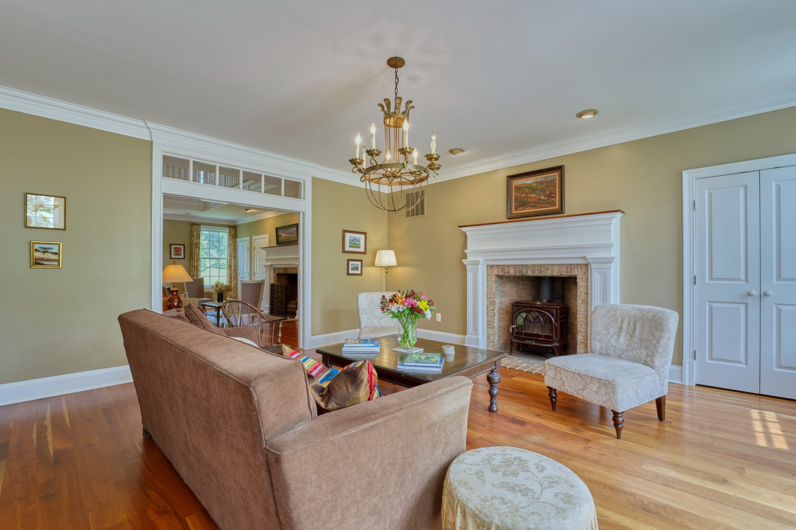 Professional interior photo of 15203 Clover Hill Road - showing a sitting room with chandelier and wood burning fireplace