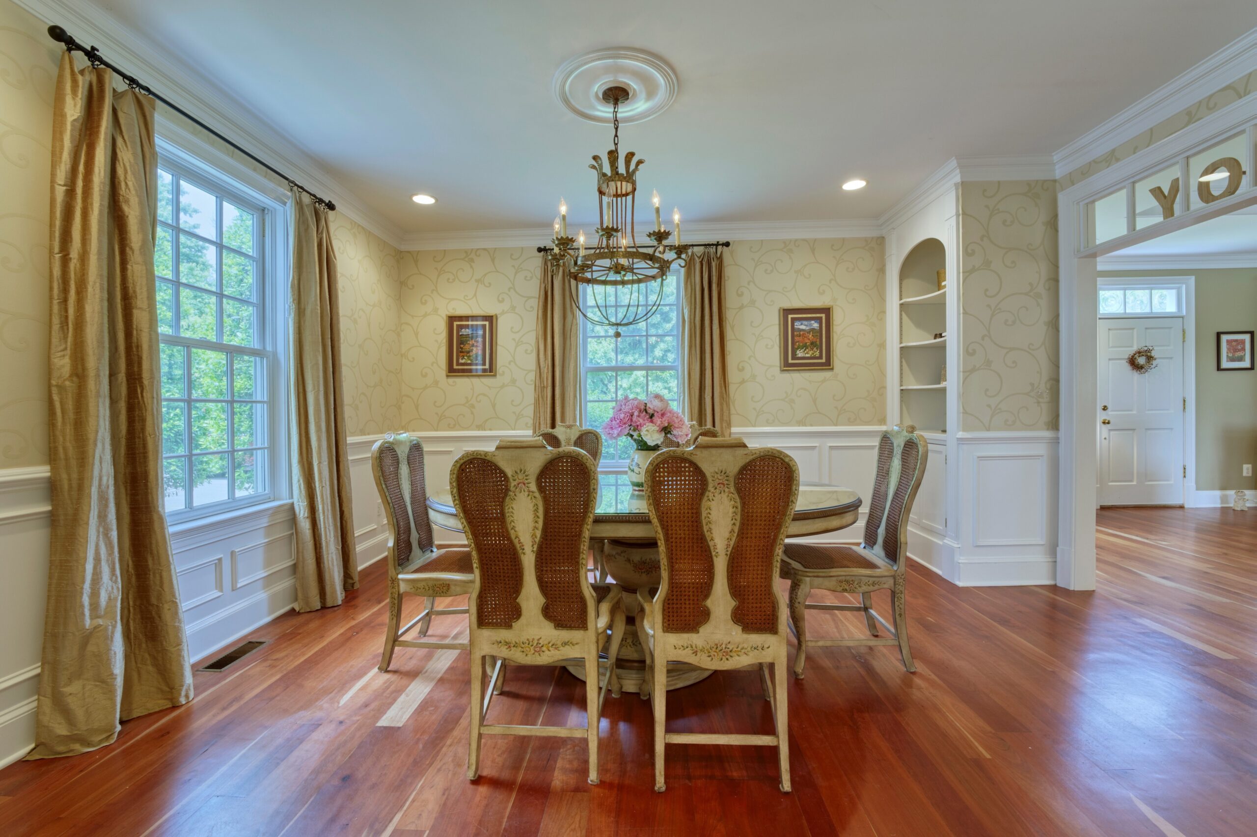 Professional interior photo of 15203 Clover Hill Road - showing the formal dining room with chandelier and cherry floors