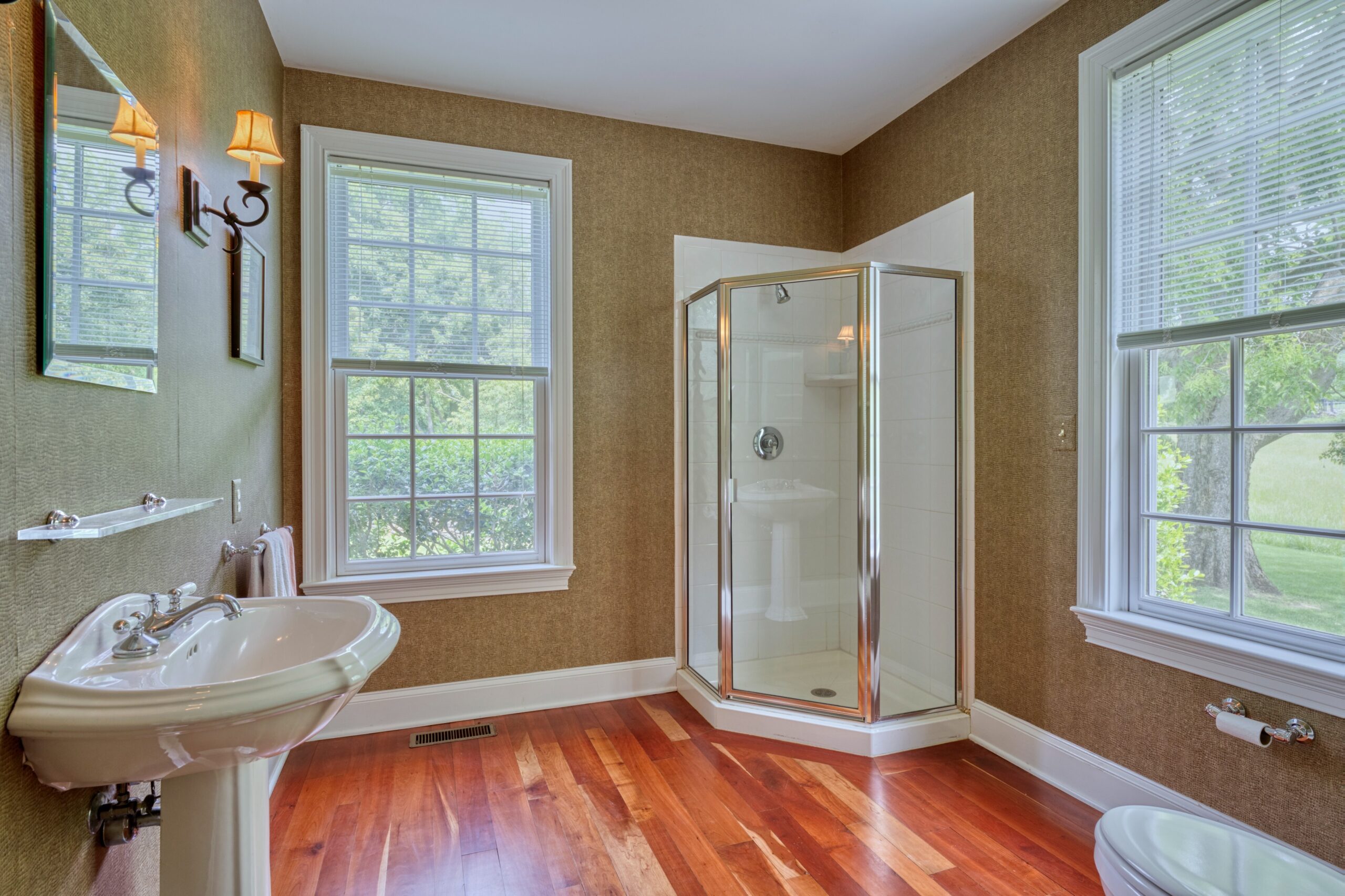 Professional interior photo of 15203 Clover Hill Road - showing a full bathroom with shower built into the corner, tiled, and cherry floors