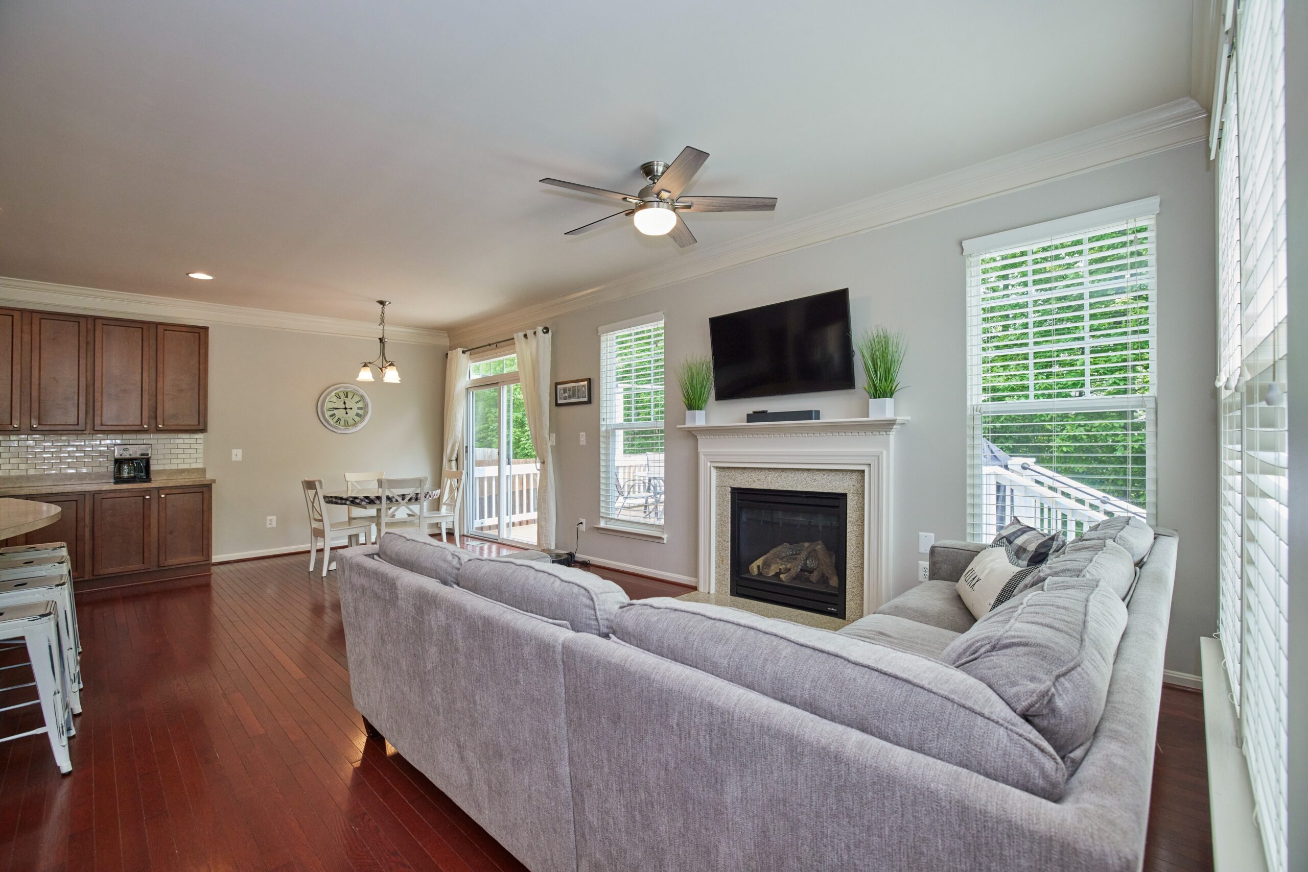 Professional interior photo of 12030 Lake Dorian Drive, Bristow, VA - showing the living room adjacent to the kitchen and the breakfast area in the background