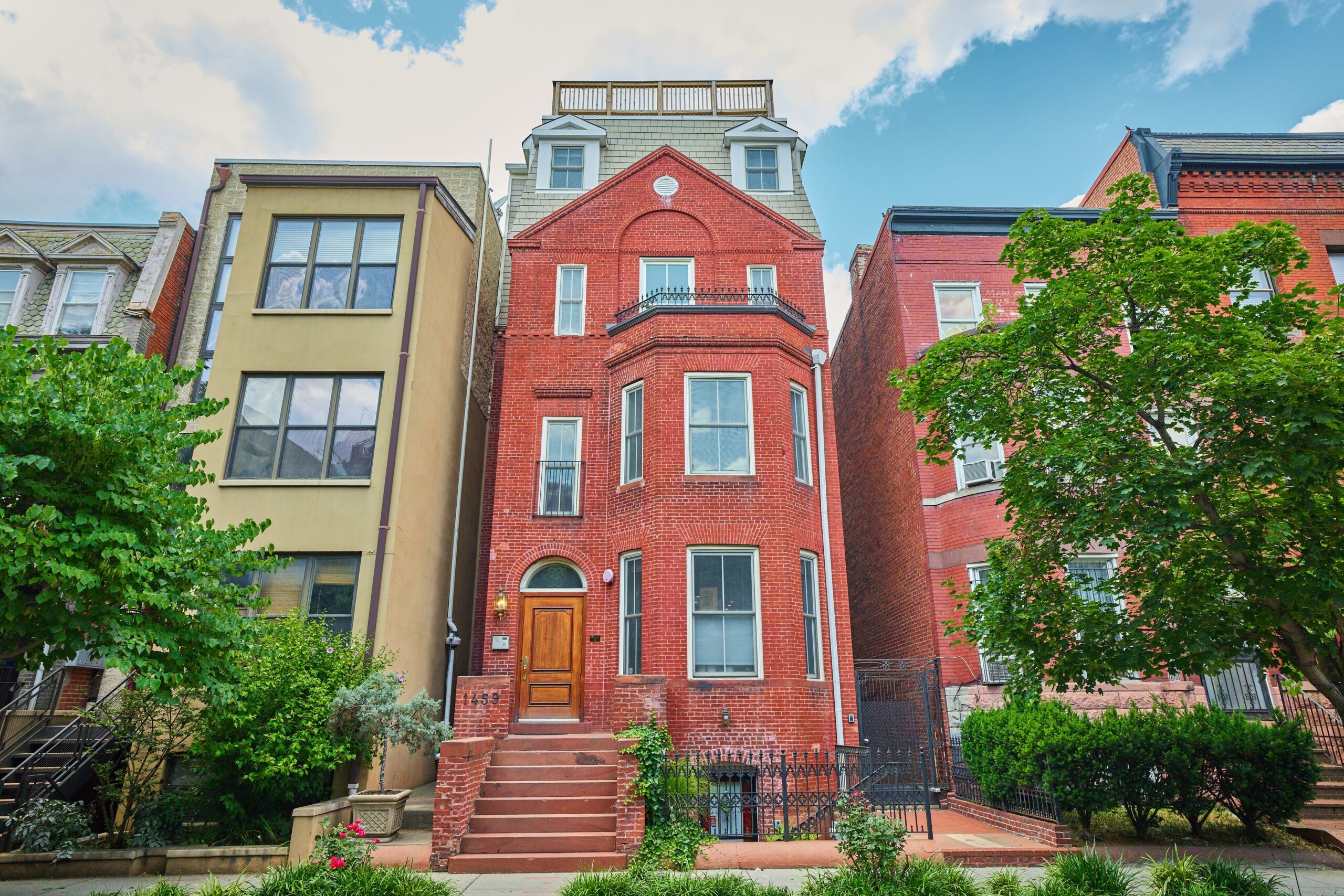 Professional exterior photo of 1459 Harvard St NW #6 - showing an all-brick, 5+ story fully detached building in Northwest Washington, DC. The entrance to #6 is through the alley to the rear