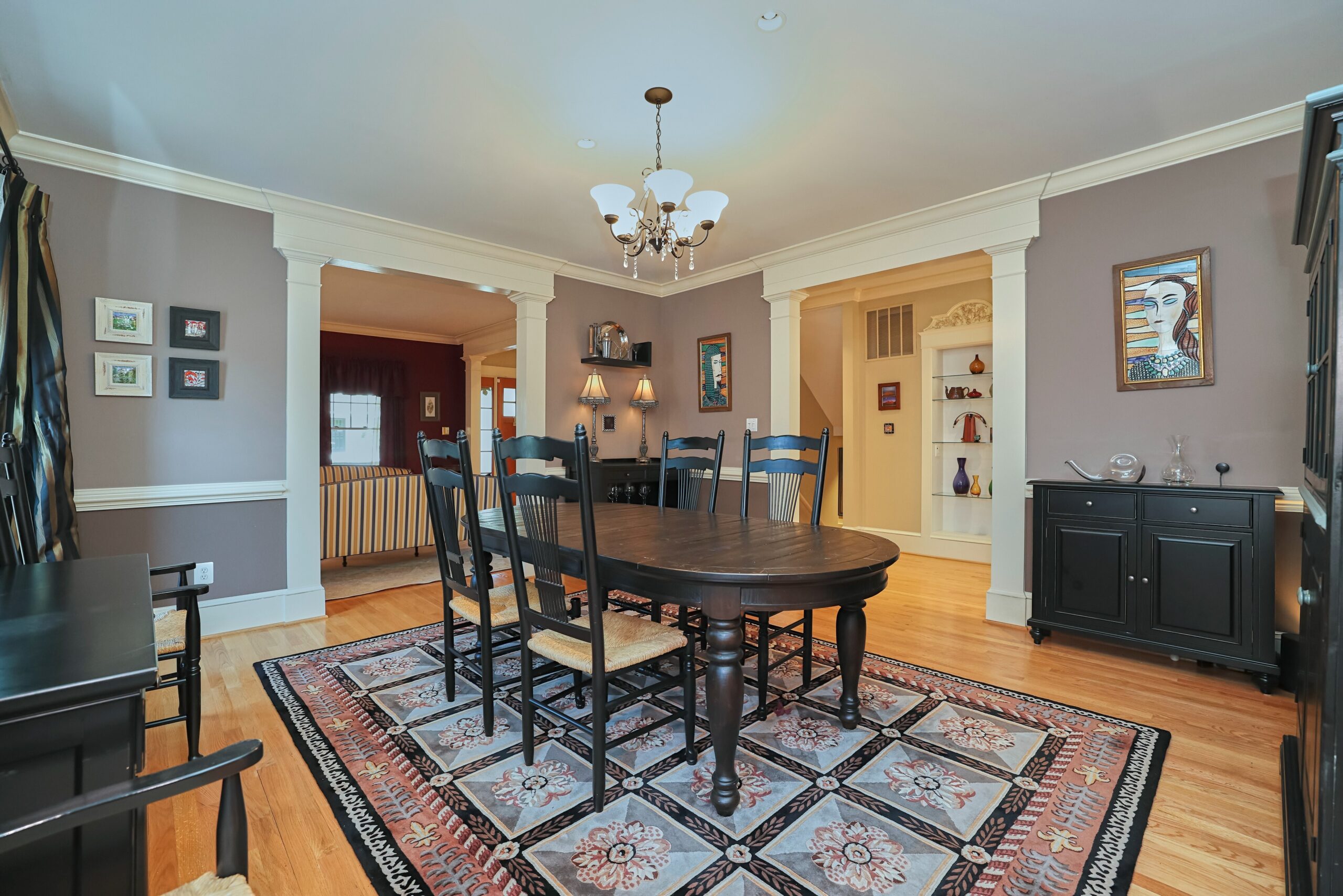 Professional interior photo of 819 N Fillmore St - Showing the dining room with grey walls and black wood furniture and hardwood floors