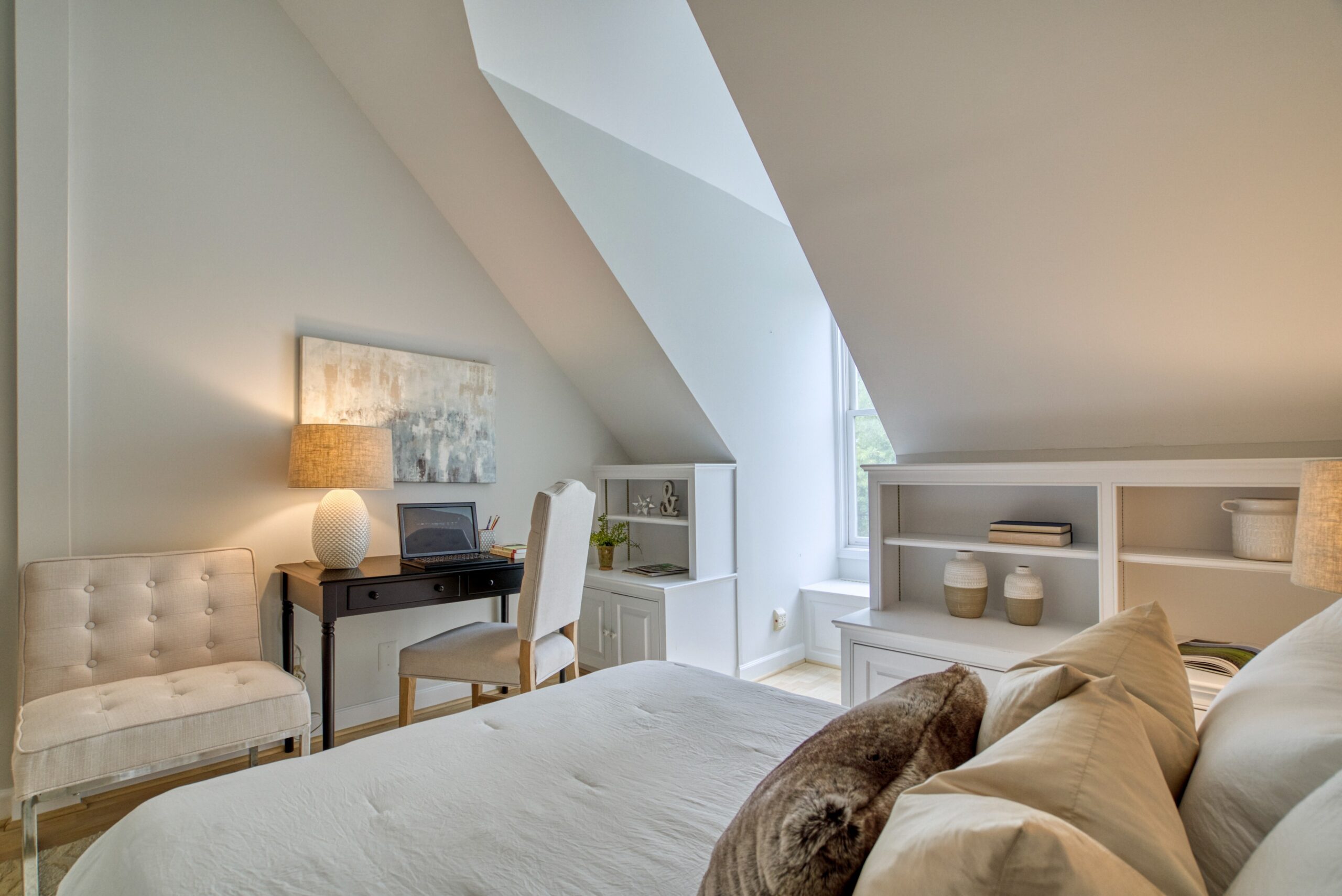 Professional interior photo of 125 N Lee St #401, Alexandria, VA - showing the second bedroom with built-in shelves, vaulted ceilings, and nook out to the window