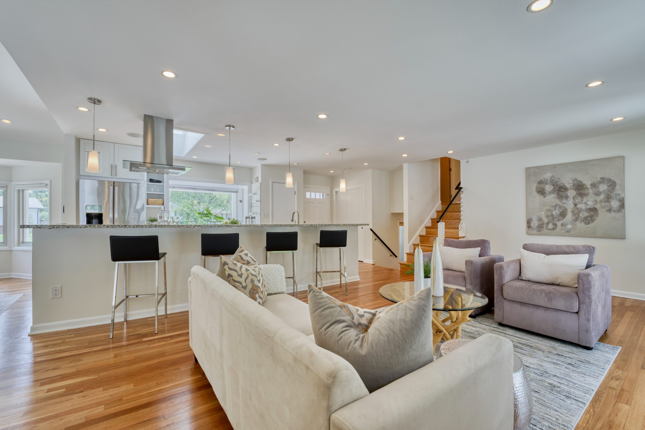 Professional interior photo of 8320 Fort Hunt Rd, Alexandria - showing the open kitchen/living room with huge center island and beautiful modern staging