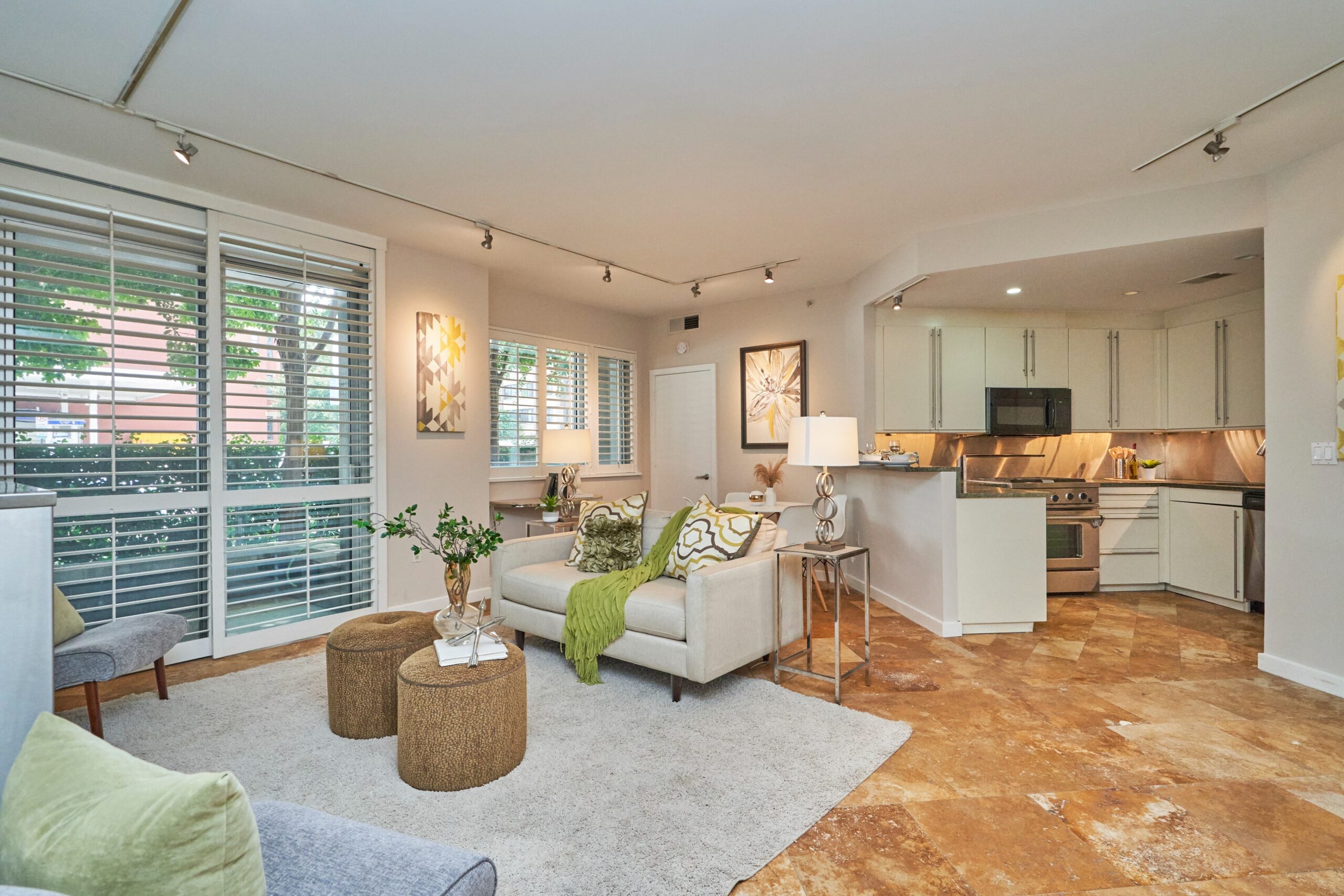 Professional interior photo of 1300 13th St NW #102, Washington DC - showing the living room view from the front entrance with marble floors and open layout