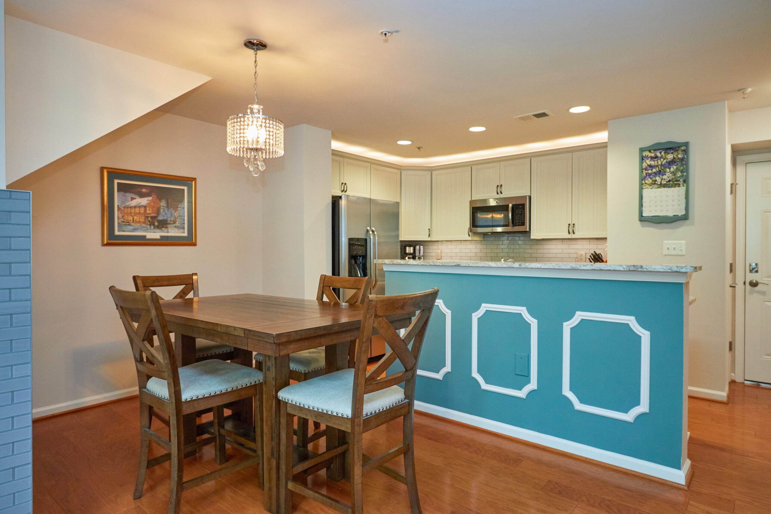 Professional interior photo of 6058 Aster Haven Circle - showing the dining room in the foreground and kitchen with large island in the background