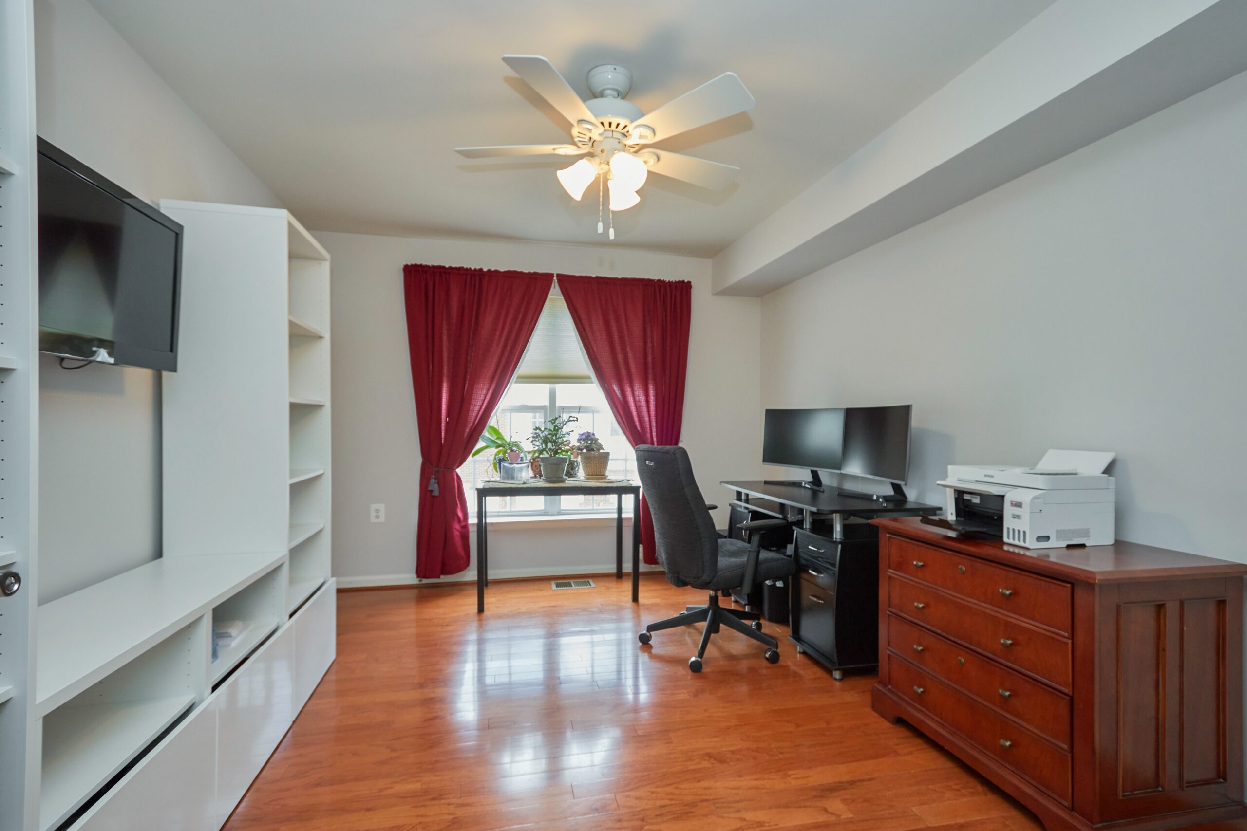 Professional interior photo of 6058 Aster Haven Circle - showing the second bedroom which is set up as an office with large white bookcases