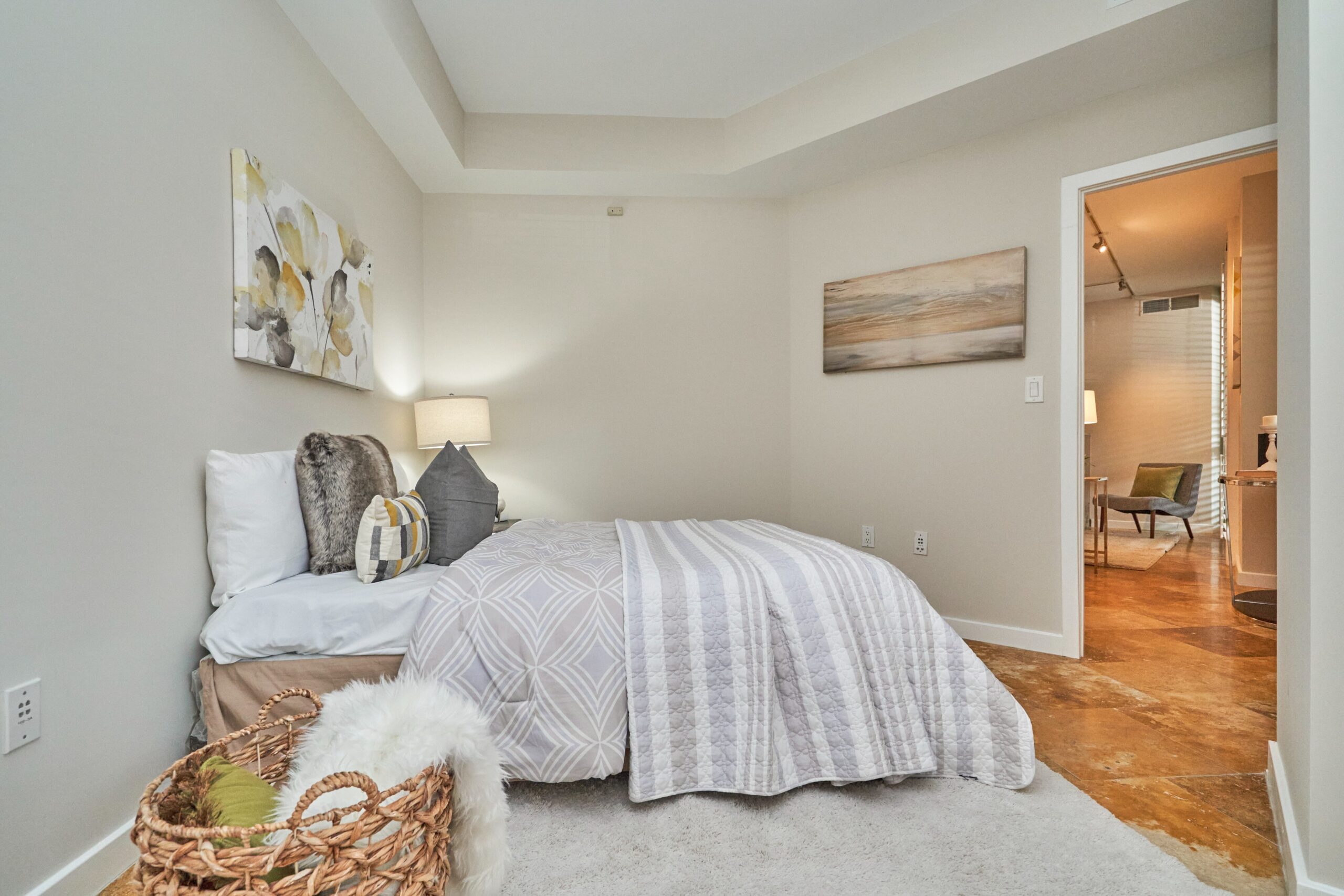 Professional interior photo of 1300 13th St NW #102, Washington DC - showing the second bedroom with tray ceiling and marble floors and unique angles