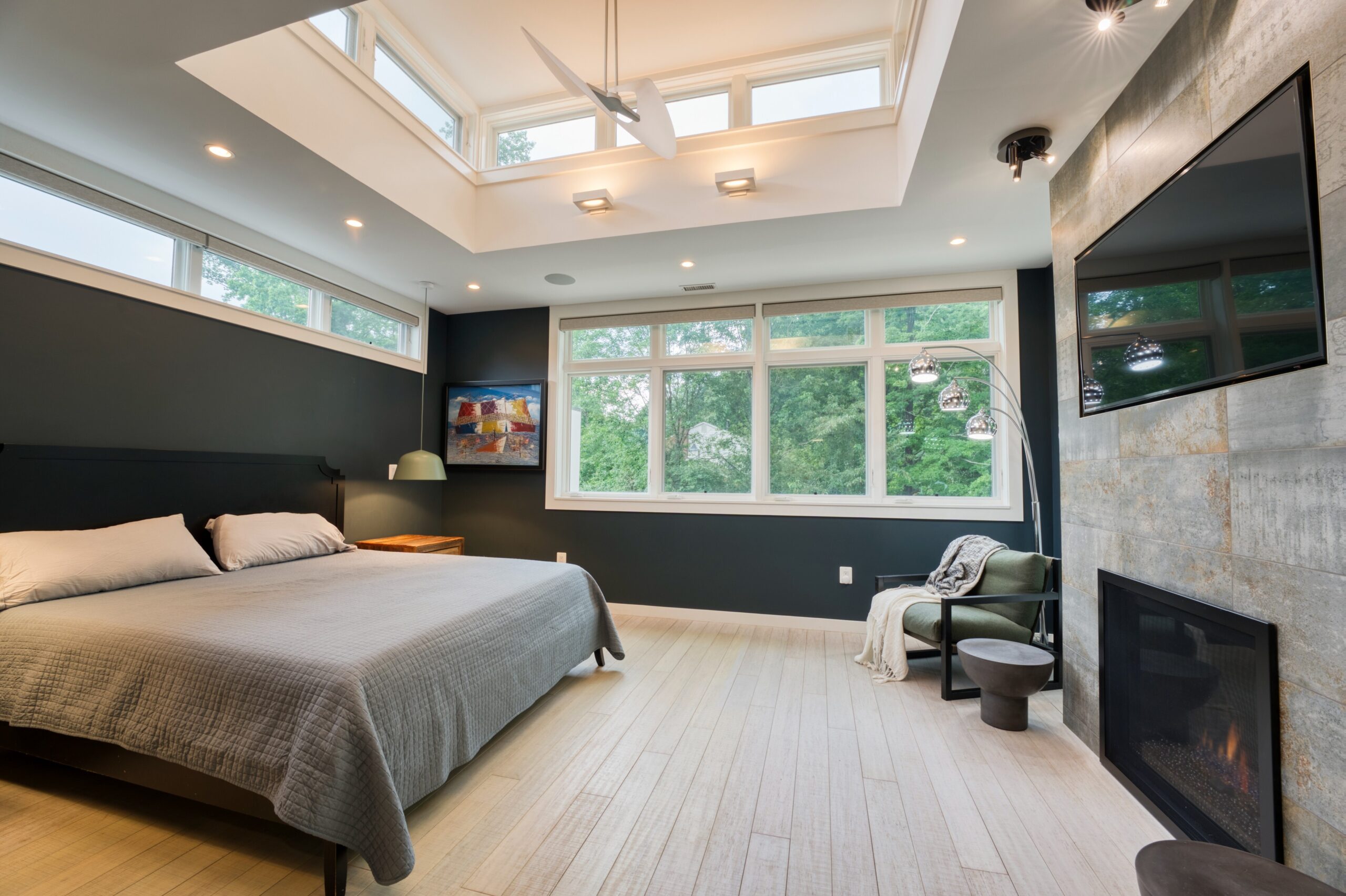 professional interior photo of 3132 Sleepy Hollow Road - showing the primary bedroom with raised skylights, bamboo floors, marble gas fireplace and mounted tv
