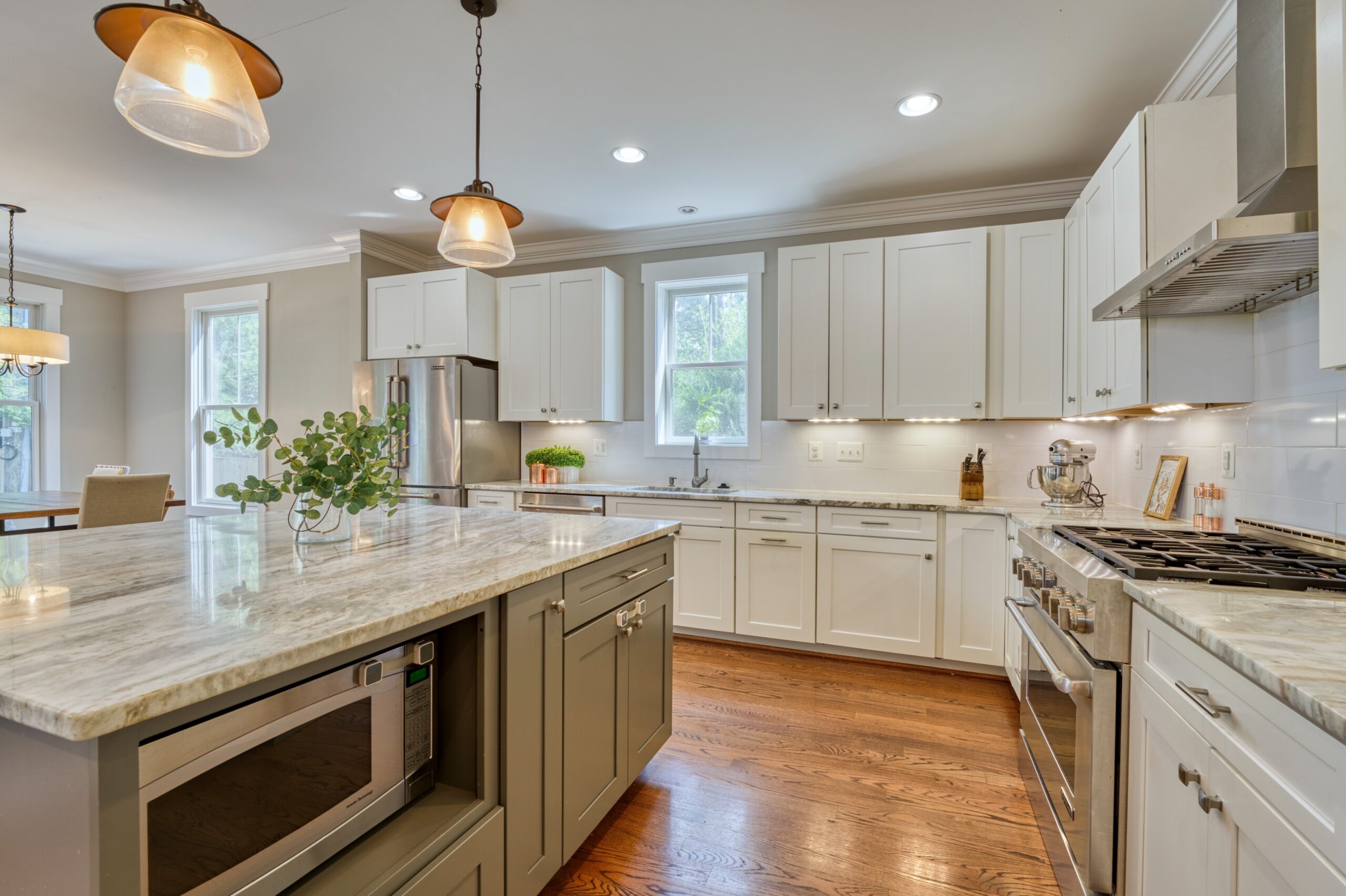 Professional interior photo of 505 N West St - showing the kitchen between the island and the range with modern cabinets and counters