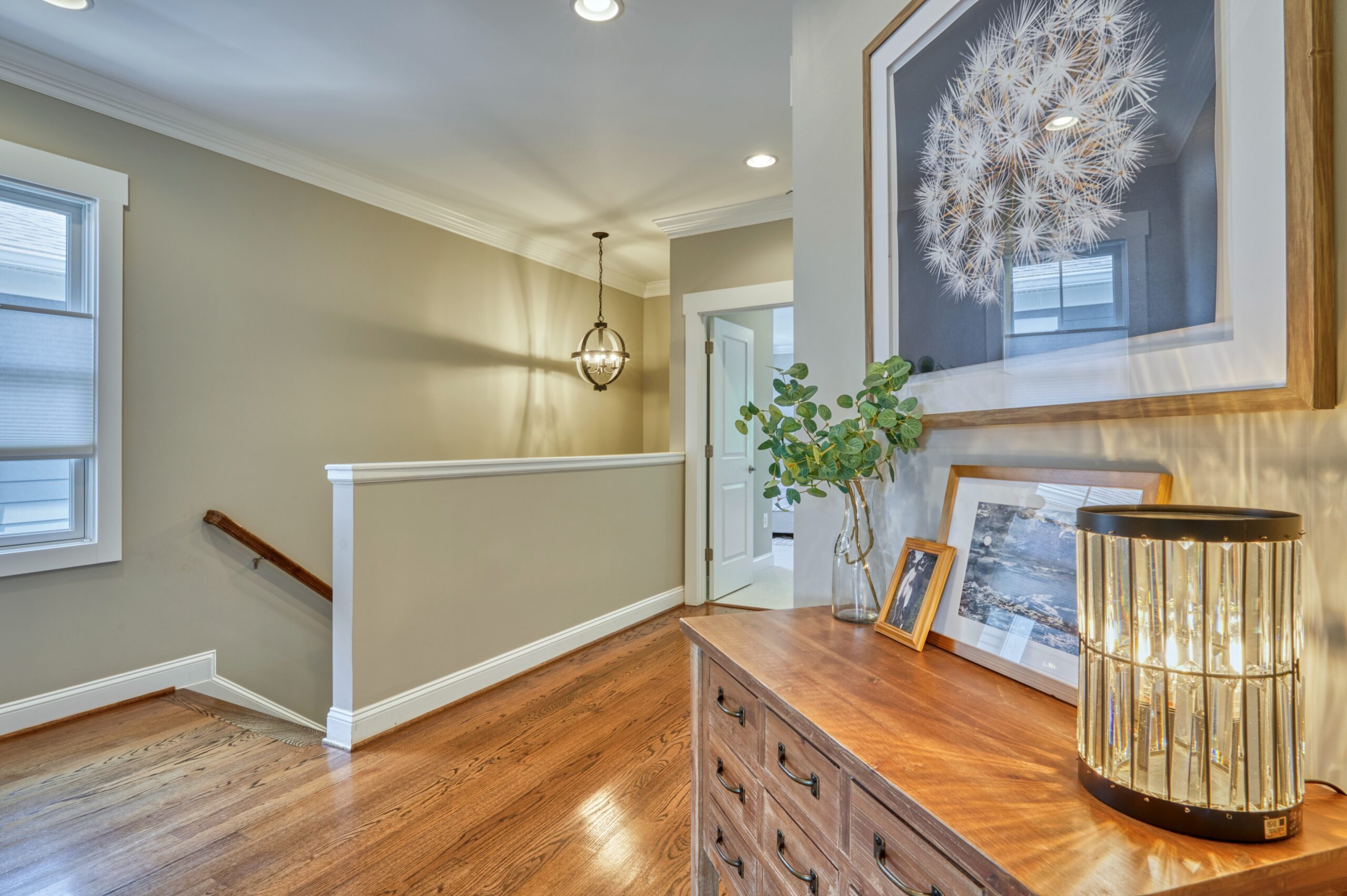Professional interior photo of 505 N West St - showing the upstairs landing with hardwood floors and a landing dresser