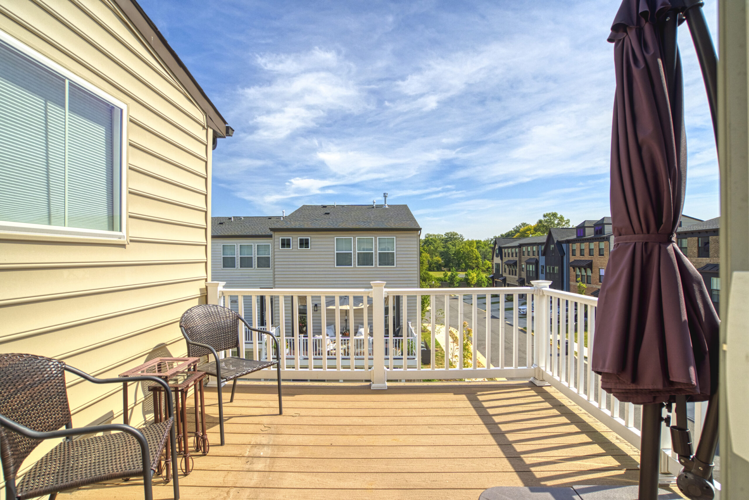 Professional exterior photo of 8109 Zoe Place, Alexandria, VA - Showing the private top floor balcony off the primary suite