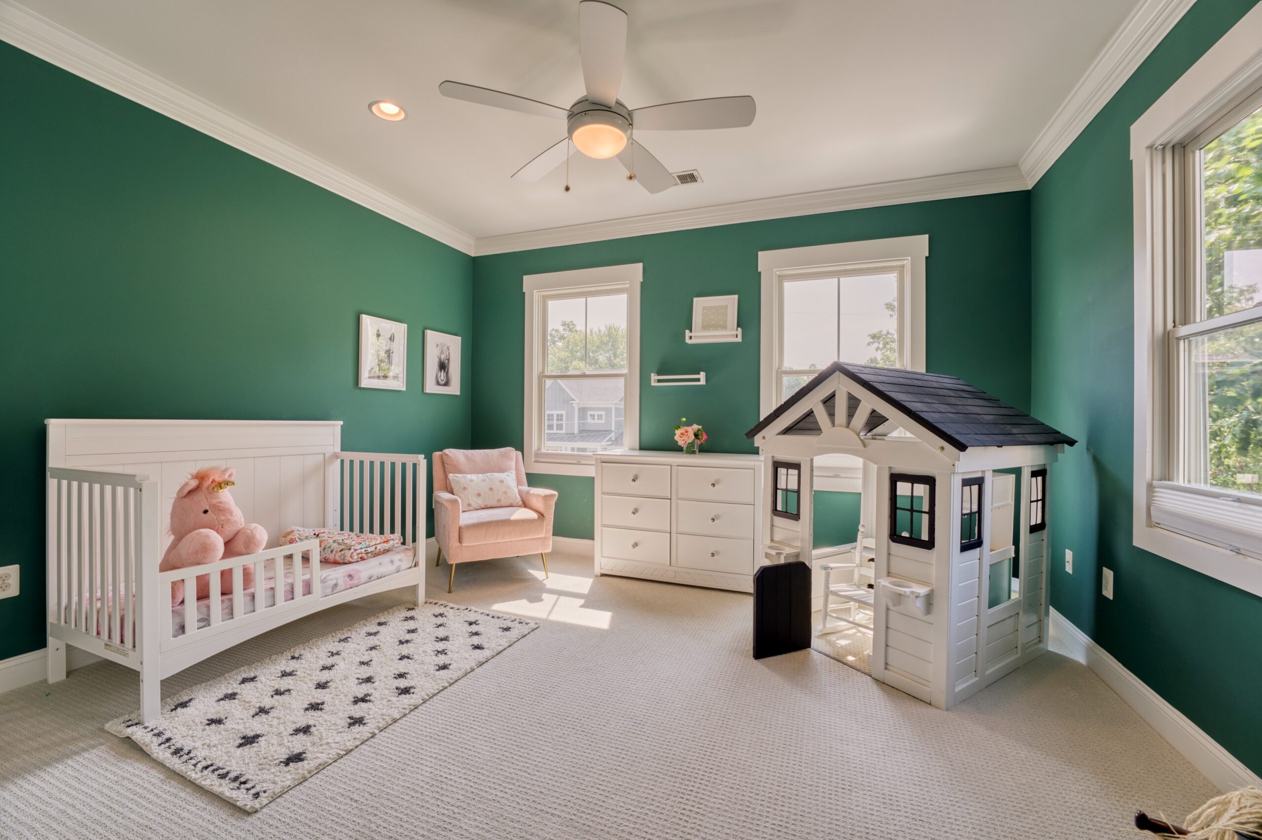 Professional interior photo of 505 N West St - showing one of the secondary bedrooms with jungle green walls and child's furniture
