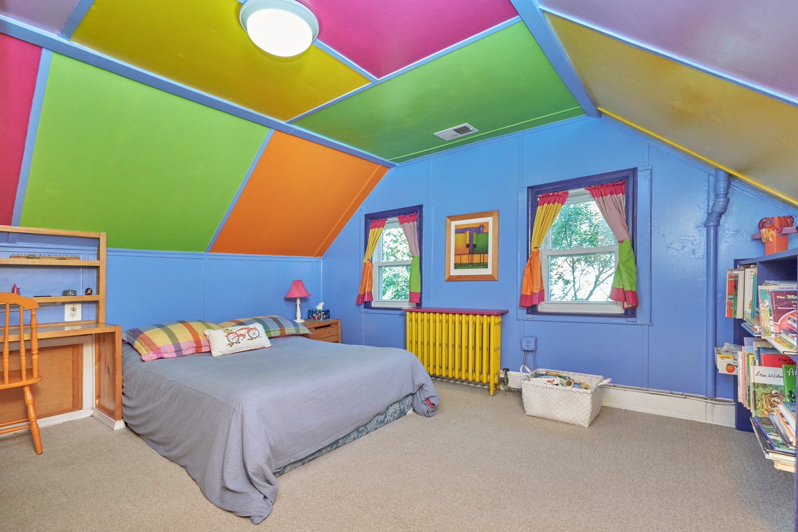 Professional interior photo of 15 N Fenwick Street - showing a top floor bedroom with vaulted ceiling painted in bright blocks of neon color