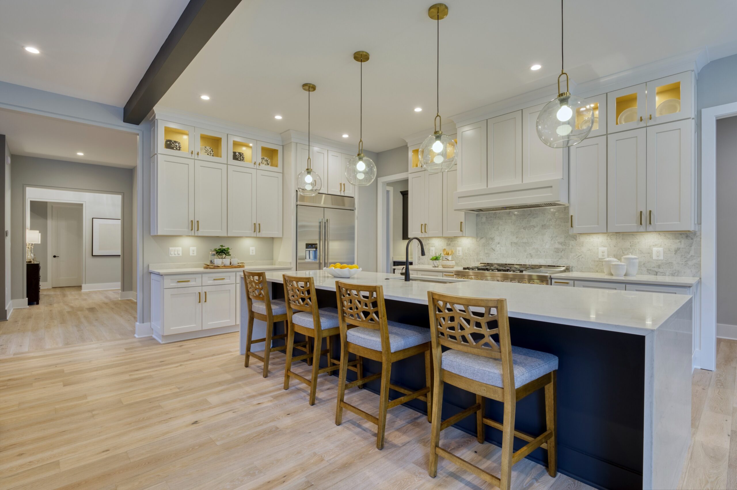 Professional interior photo of new construction home at 3400 N Ohio St - showing the white kitchen with black and gold accents. Large island and high end appliances