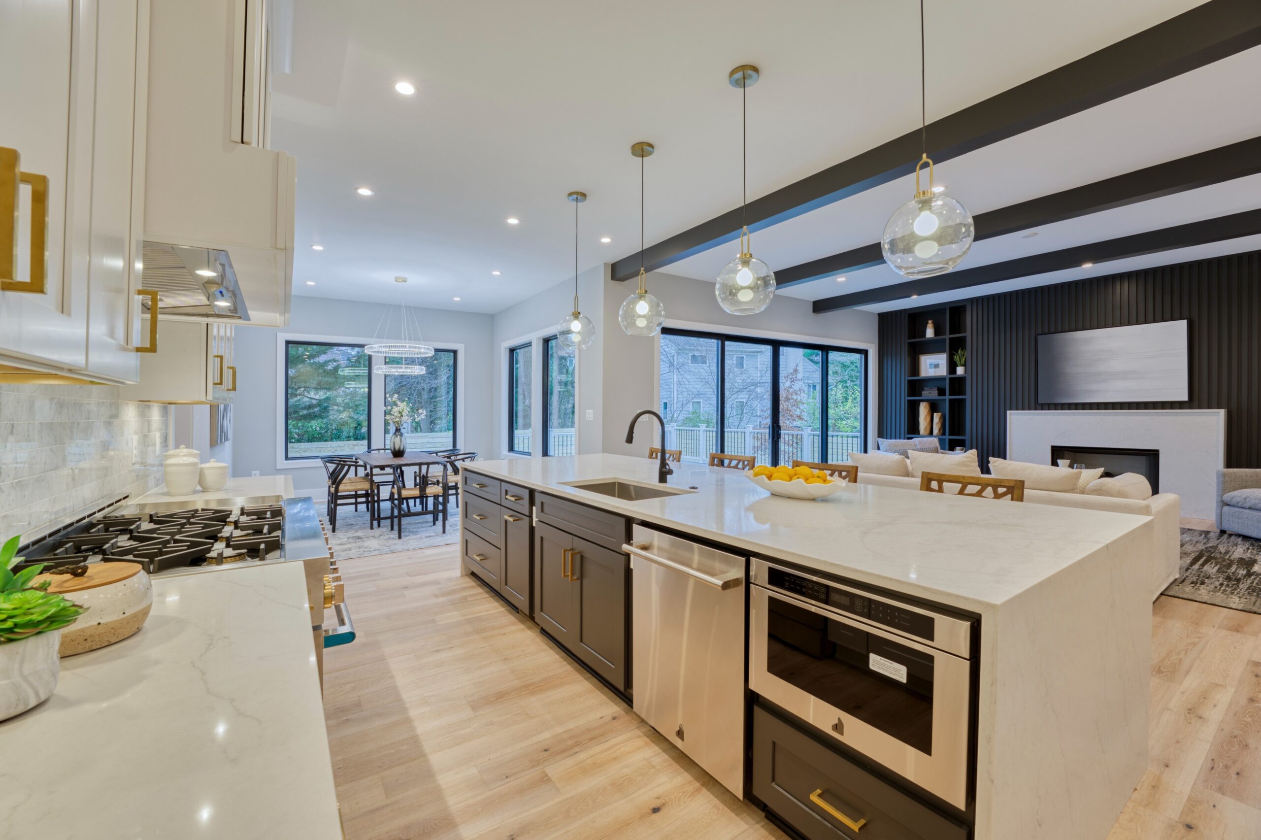 Professional interior photo of new construction home at 3400 N Ohio St - showing the white kitchen with black and gold accents. Large island and high end appliances