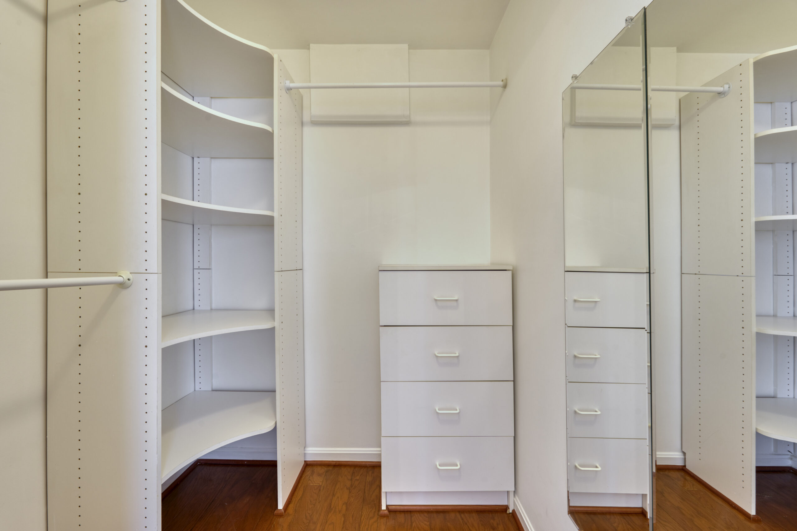 Professional interior photo of 20588 Cornstalk Ter Unit 101 - Showing the walk-in closet for one of the primary suites with built-in shelves