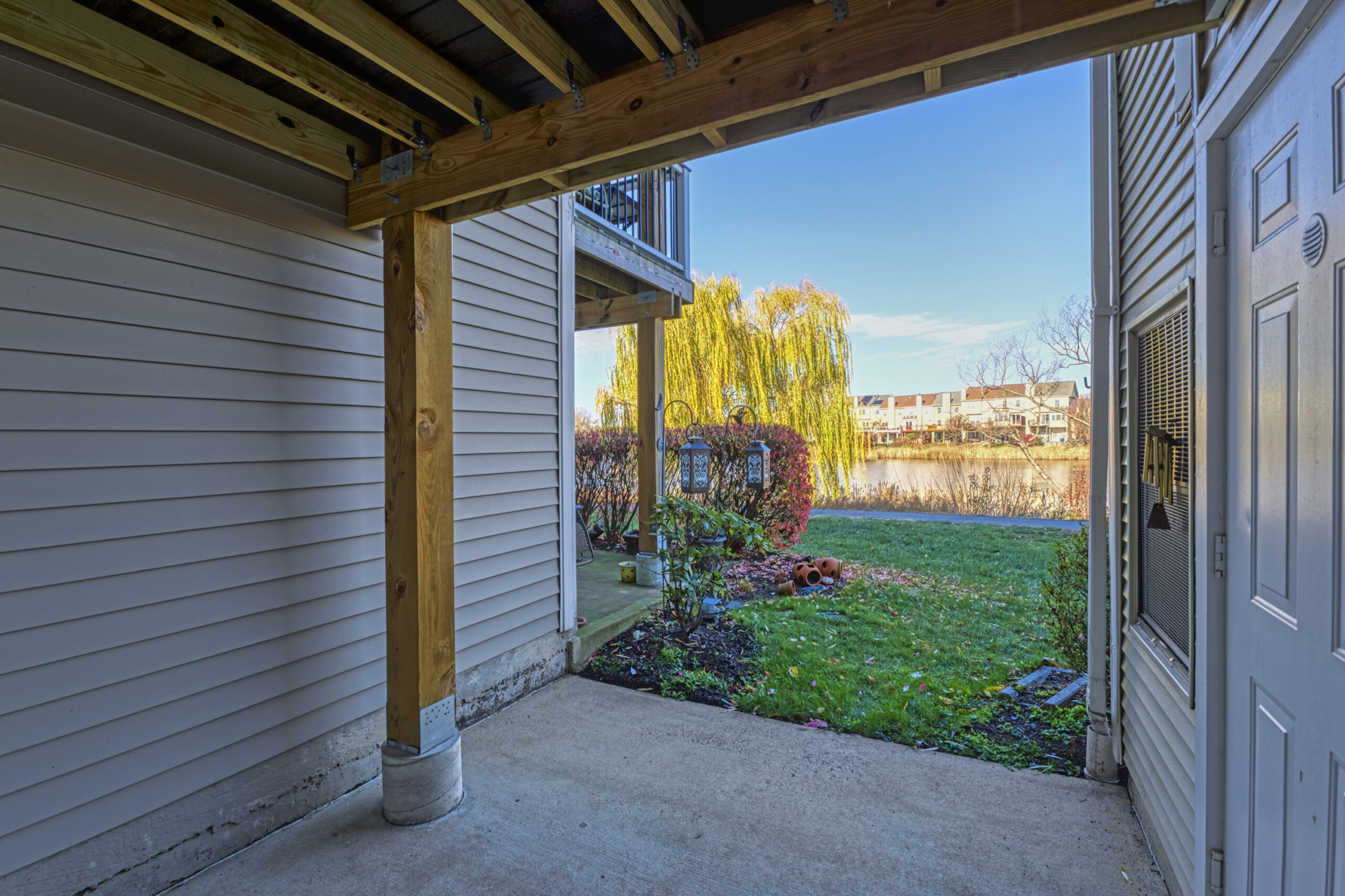 Professional exterior photo of 20588 Cornstalk Ter Unit 101 - Showing the rear patio of the unit on the ground floor 