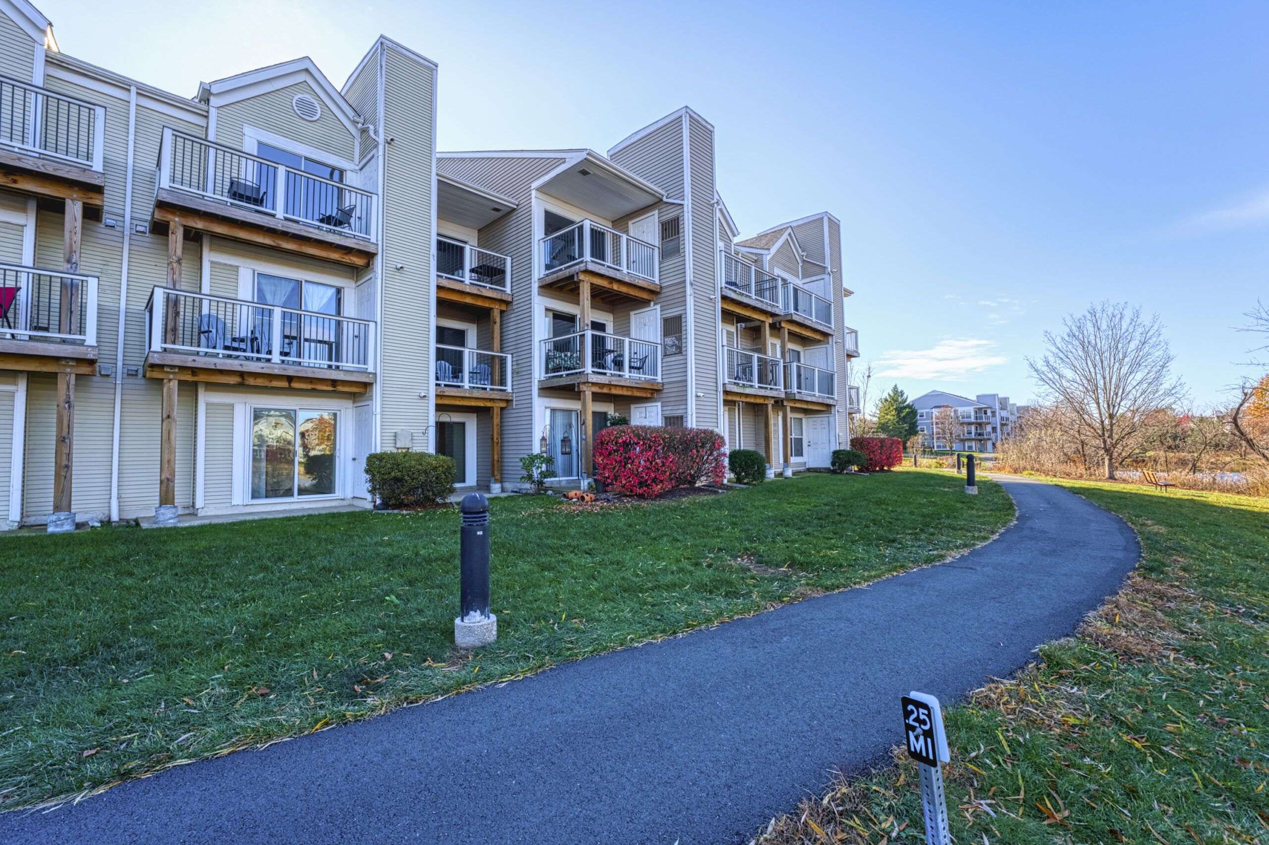 Professional exterior photo of 20588 Cornstalk Ter Unit 101 - Showing the walking path behind the condo building
