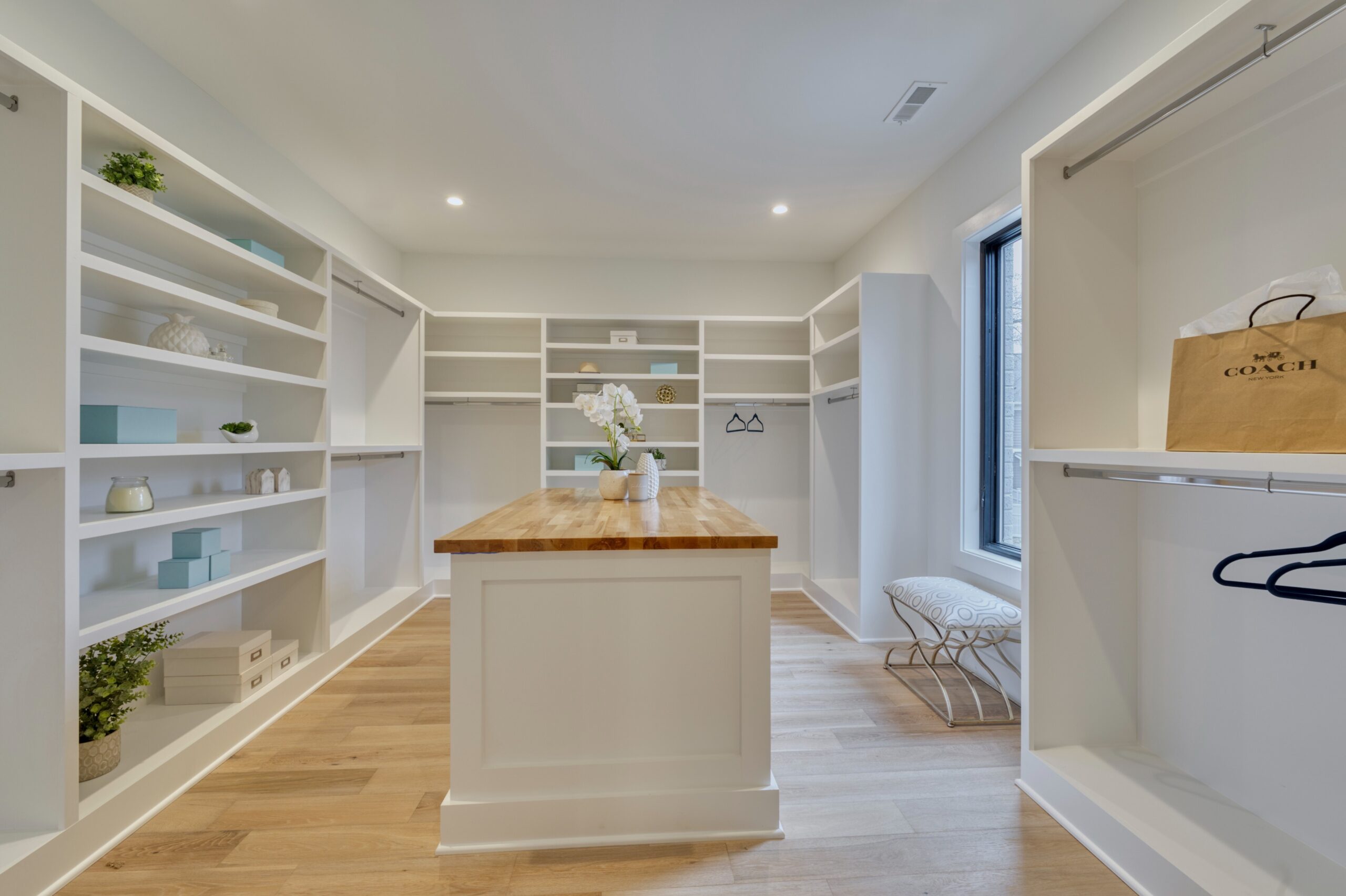 Professional interior photo of new construction home at 3400 N Ohio St - showing the primary walkin closet with bult in shelves, racks and a center island