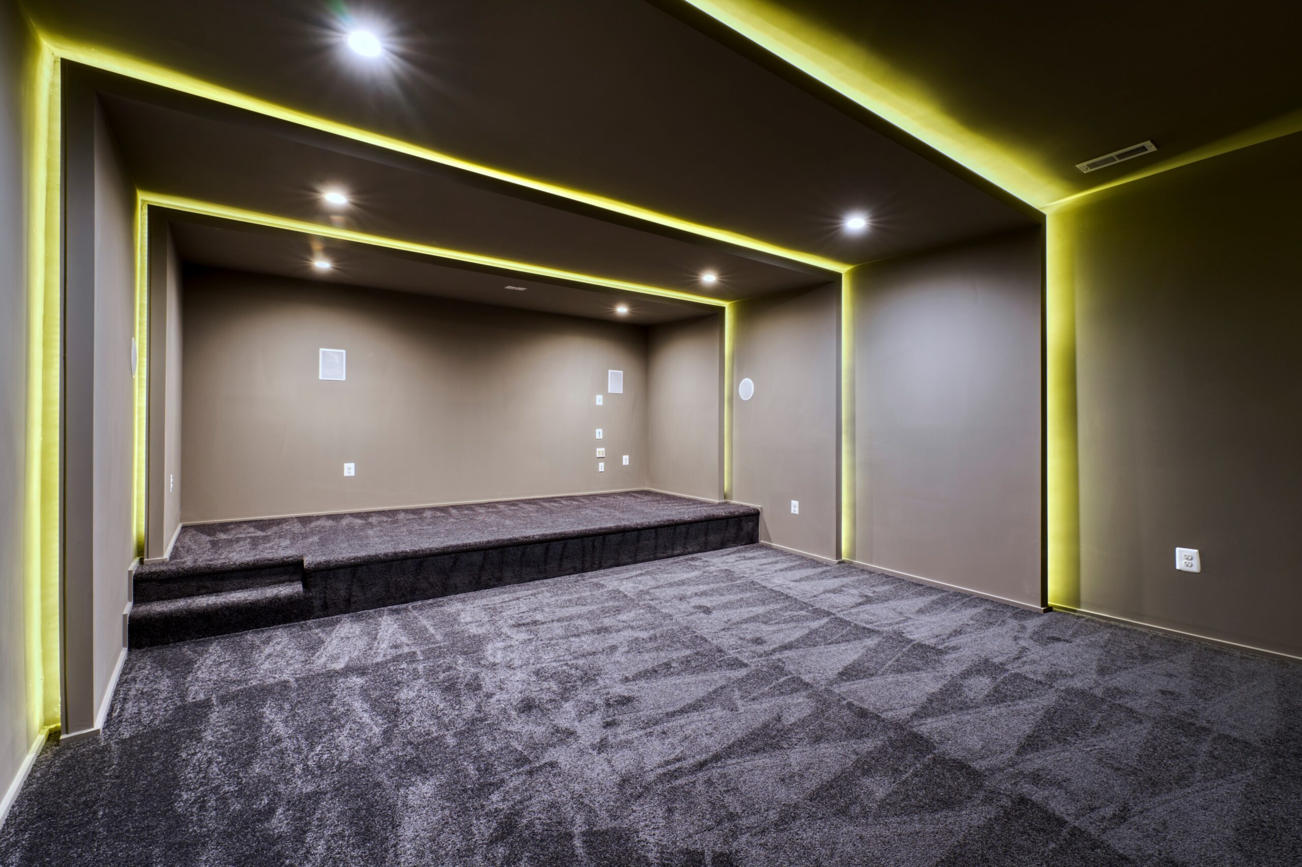 Professional interior photo of new construction home at 3400 N Ohio St - showing the movie theater room with led lighting, plush carpeting and a second tier for the back row of seats
