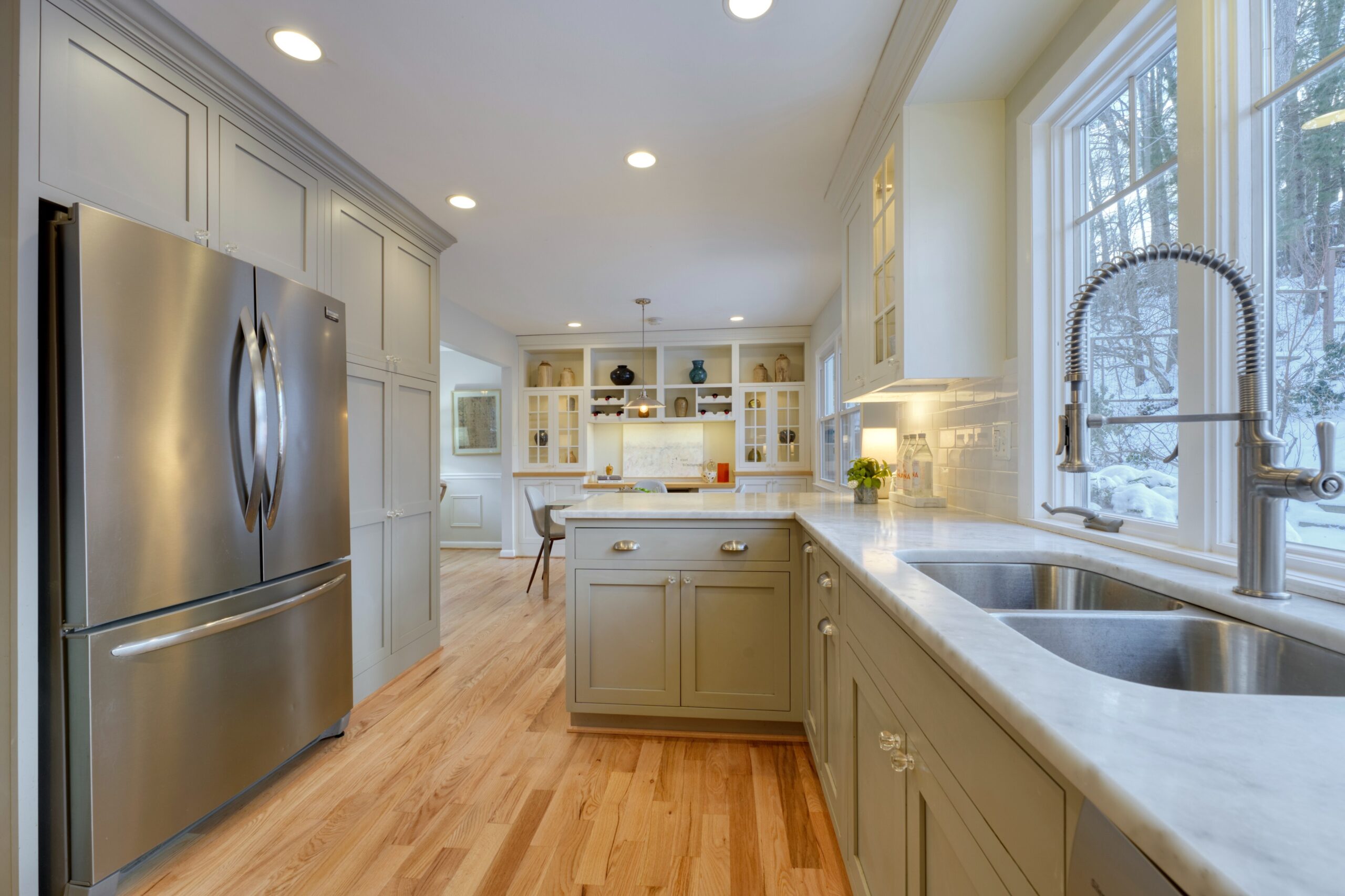Professional interior photo of 9515 Center St in Vienna, Virginia - showing the kitchen with grey cabinets, stainless appliances and stone counters